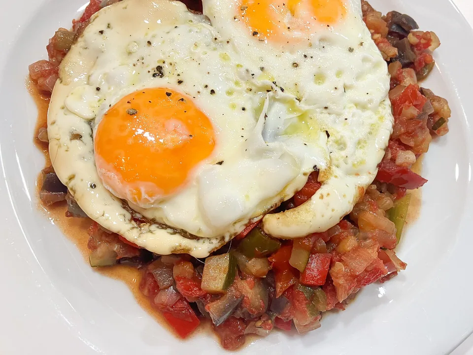 Thick Manchegan vegetable pisto with peppers, courgette and soft cooked eggs