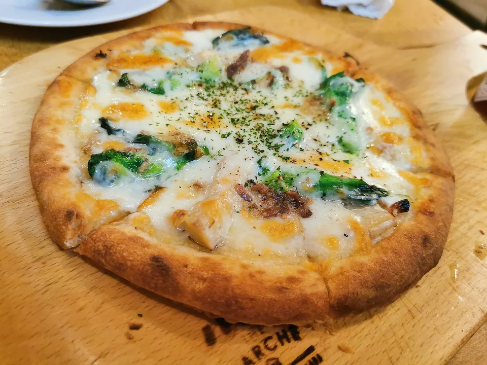 Margherita pizza with blistered crust, tomato, melted mozzarella and basil
