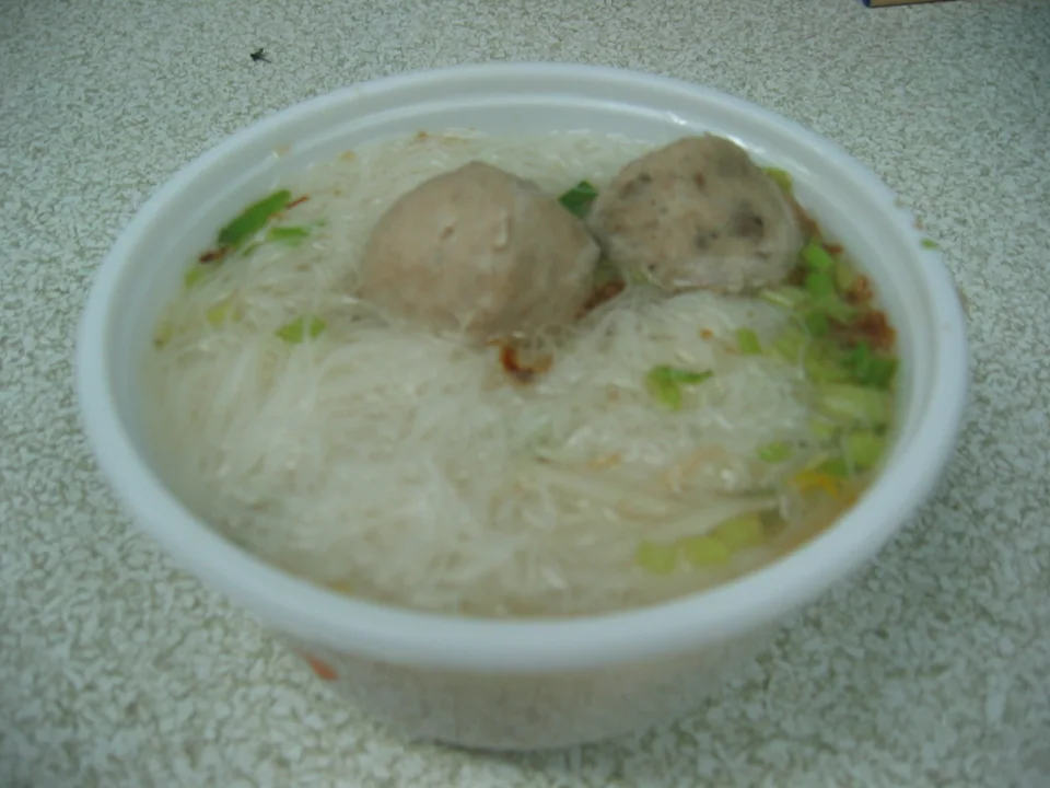 Clear pork ball rice vermicelli soup with daikon, celery, fried shallots, and white pepper
