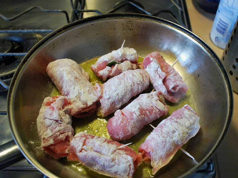 Veal saltimbocca topped with prosciutto and sage in glossy wine-butter sauce