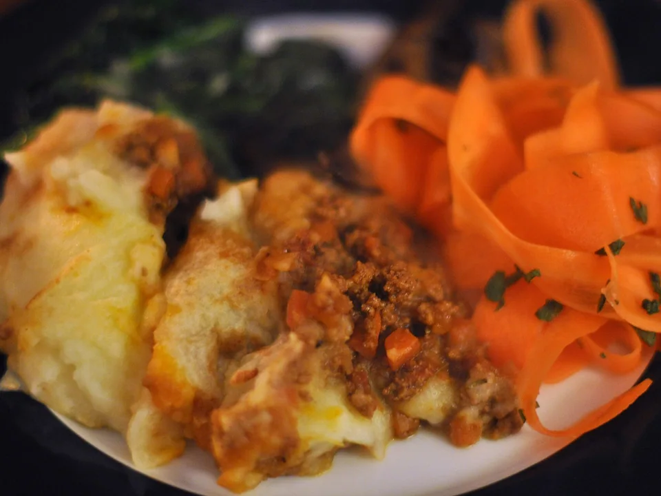 Golden shepherd's pie with fork-ridged mashed potato over lamb filling