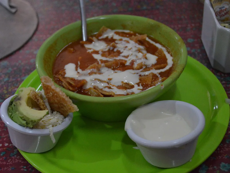 Tortilla soup with crisp strips, avocado, queso fresco and crema