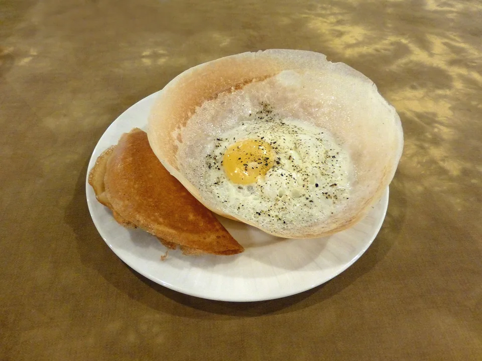 Sri Lankan egg hopper with fermented rice batter, lacy crisp rim and egg centre