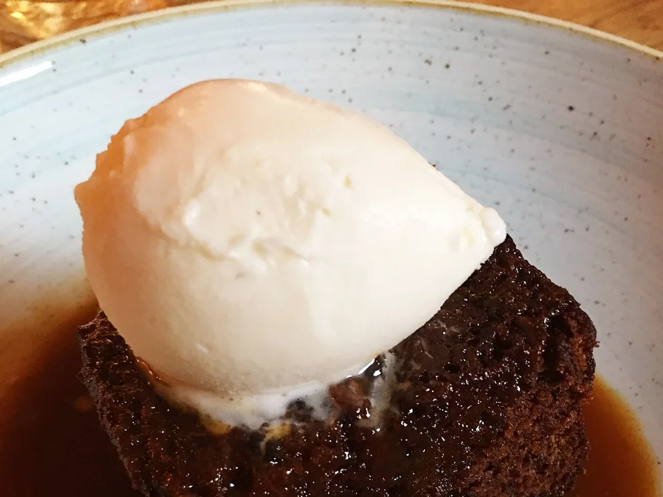 Sticky toffee pudding with dark date sponge and glossy toffee sauce