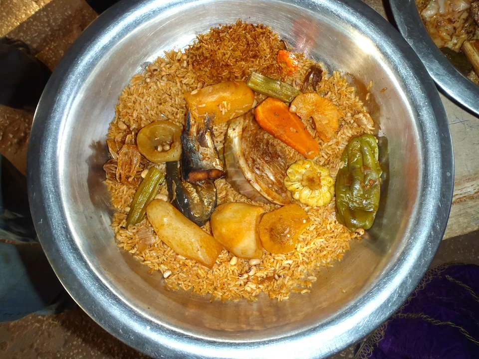 Senegalese thieboudienne with fish, broken rice, cassava, cabbage, carrots and okra