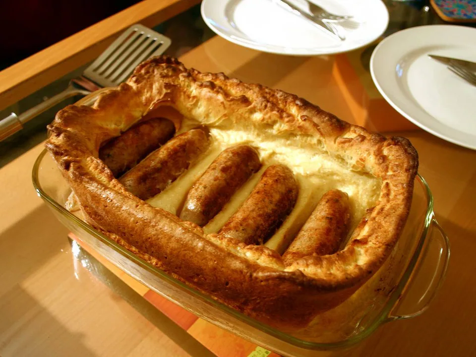 Sausages baked in a tall golden Yorkshire pudding with onion gravy