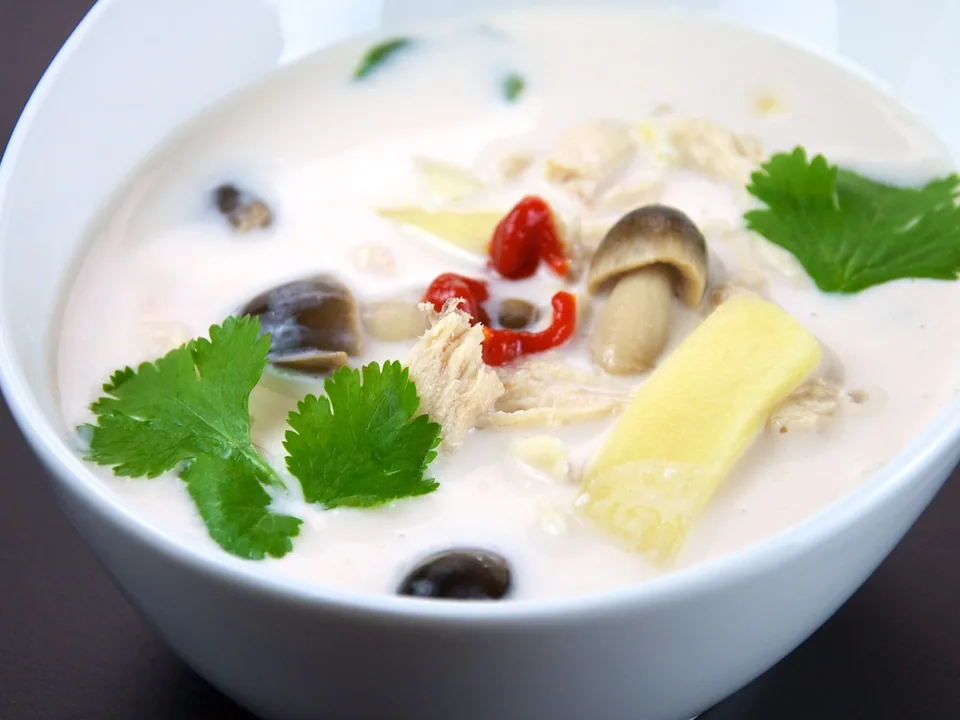 Tom Kha Gai coconut chicken soup with galangal, lemongrass, lime leaves, mushrooms, chile, and cilantro