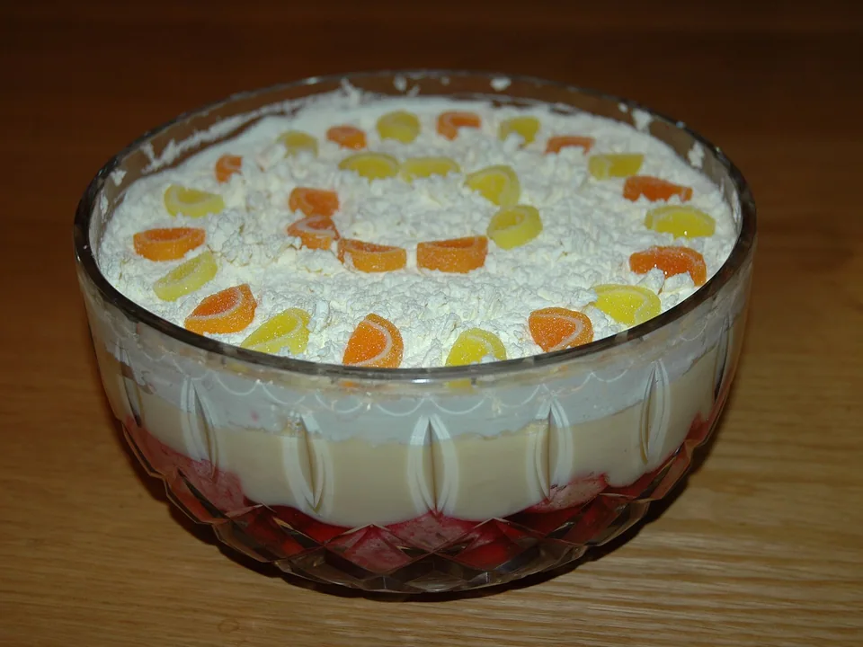 Glass-bowl British trifle with sponge, berry jelly, custard and cream layers