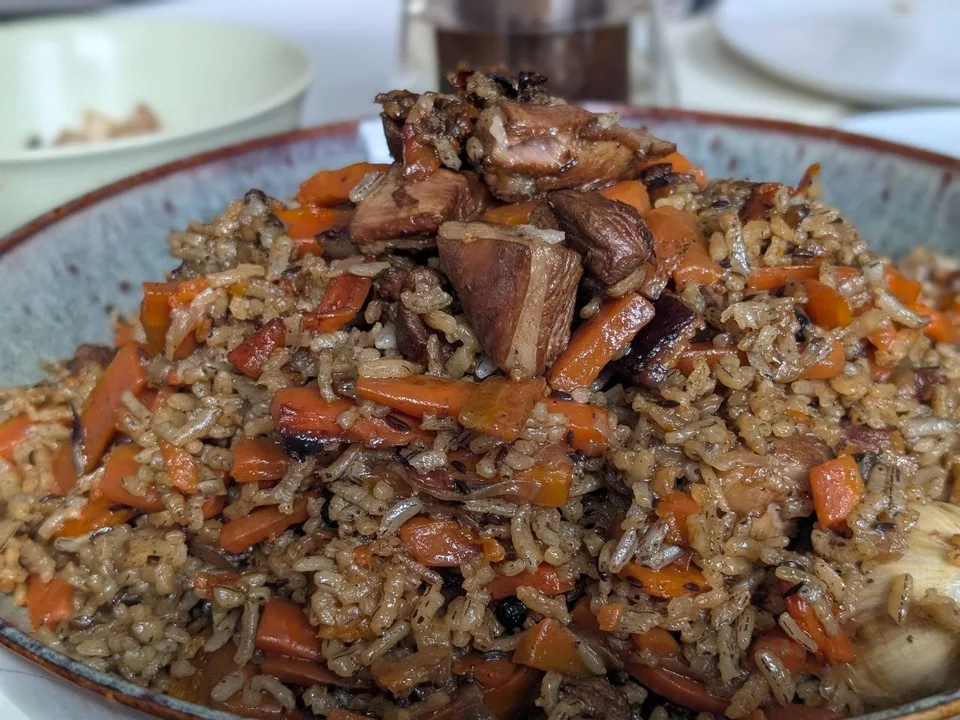 Uzbek plov of long-grain rice, lamb, carrots, cumin and whole garlic