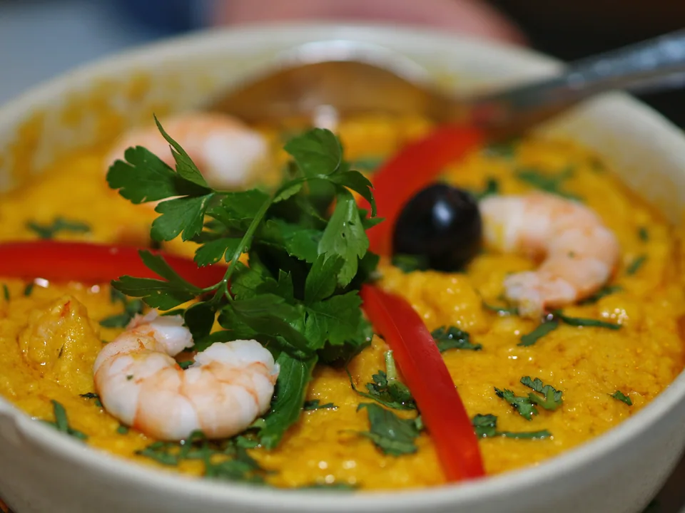 Vatapá with shrimp in a glossy coconut, bread and nut sauce beside rice